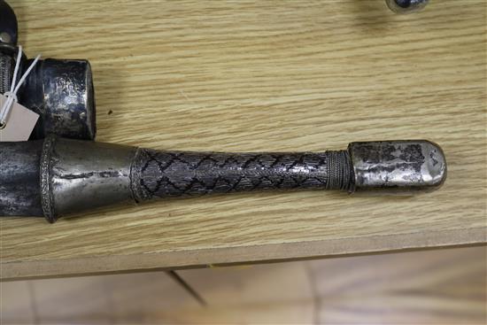 A Songye style ceremonial axe, the wooden handle covered in snakeskin, a Ngala style tribal knife and an Indian long sword,